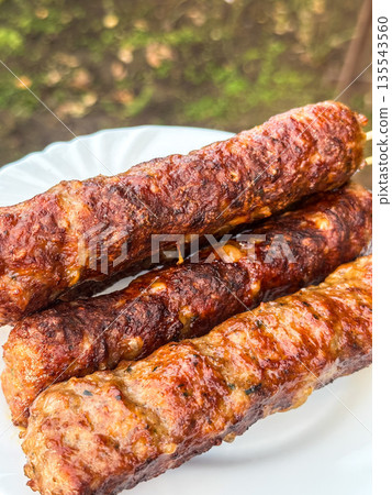 Grilled kebabs on a plate 135543560