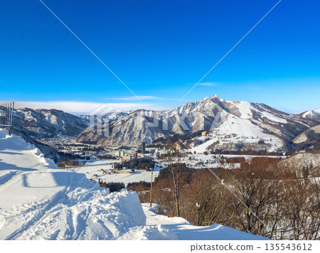 A snowy winter scene in Yuzawa Town and a distant view of Iwappara Ski Resort, with its distinctive wide slopes (Yuzawa Town, Niigata Prefecture) A snowy winter scene in Yuzawa Town and a distant view of Iwappara Ski Resort, with its distinctive wide slopes (Yuzawa Town, Niigata Prefecture) 135543612
