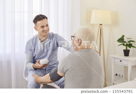 Nurse measure blood pressure of a sick senior mature male patient visiting him at home. Nurse measure blood pressure of a sick senior mature male patient visiting him at home. 135543791