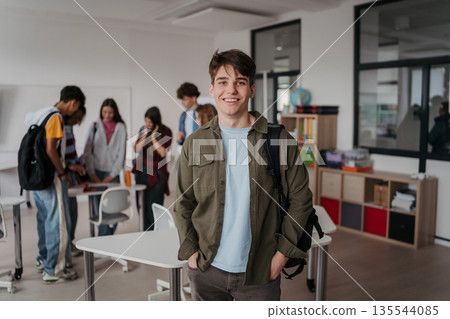 Confident teen student in classroom in school. 135544085