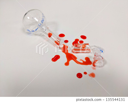 A shattered flask and spilled liquid create a dramatic visual, possibly representing a science experiment gone wrong A shattered flask and spilled liquid create a dramatic visual, possibly representing a science experiment gone wrong 135544131