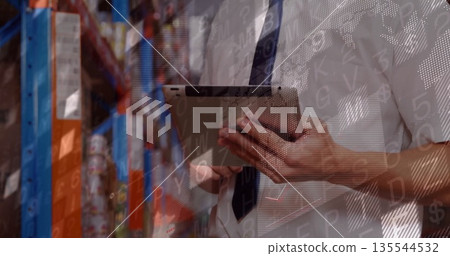 Holding tablet, supervisor scanning data overlay in warehouse aisle, with racks, boxes and cans Holding tablet, supervisor scanning data overlay in warehouse aisle, with racks, boxes and cans 135544532
