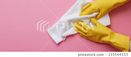 Hands in Yellow Gloves Cleaning with a White Towel 135544553