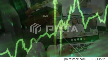 Typing man on sofa using laptop in living room, showing woman holding document, coffee mug, graph 135544594