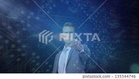 Pointing business professional wearing grey suit at digital interface, with circuit patterns Pointing business professional wearing grey suit at digital interface, with circuit patterns 135544746