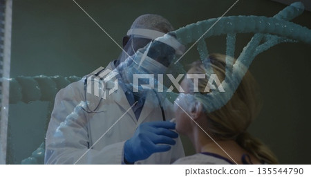 Doctor wearing white coat administering nasal swab to patient in exam room, with DNA helix graphic 135544790