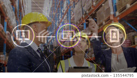 Managers wearing safety vest and hard hats checking boxes in warehouse aisle, with digital icons 135544795