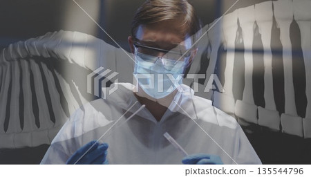 Handling sample tubes scientist in white suit and gloves in dark lab, DNA helix overlay 135544796