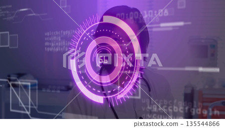 Female doctor wearing white coat analyzing data behind HUD panel in exam room, with stethoscope 135544866