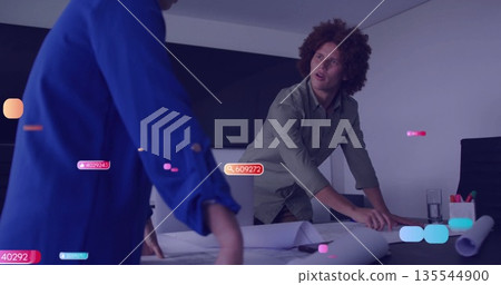 Leaning professionals in business attire reviewing blueprints in conference room, with digital tags Leaning professionals in business attire reviewing blueprints in conference room, with digital tags 135544900