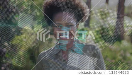 Using digital overlays African American woman interacting in lush garden, data visualization 135544923