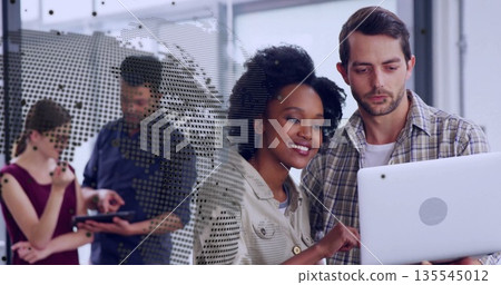 Examining laptop screen coworkers in office with smartphone tablet and dotted glass map partition Examining laptop screen coworkers in office with smartphone tablet and dotted glass map partition 135545012