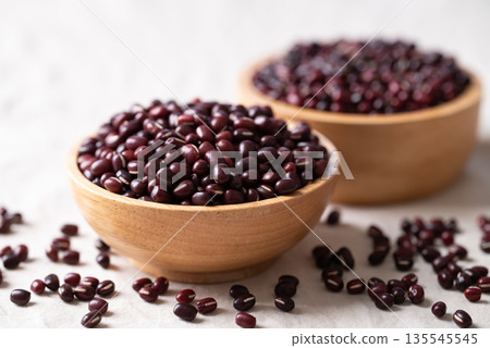 Azuki beans, Adzuki bean or red mung beans in wooden bowl on white fabric background 135545545