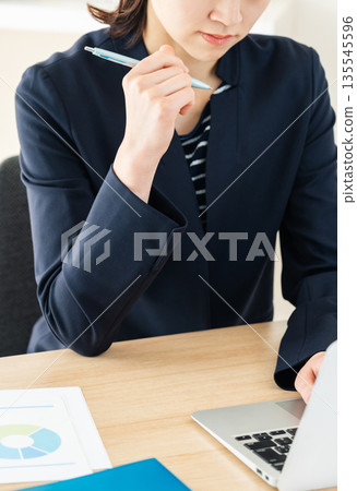 Business woman thinking in office Business woman thinking in office 135545596