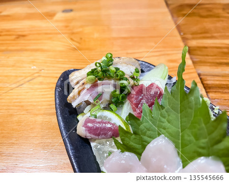 Fresh chicken sashimi, including chicken thighs, hearts, and gizzards. 135545666