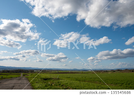 Grass fields and rural roads with an airfield 135545686