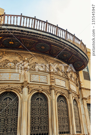 Historic Qalawun Complex in Cairo, featuring intricate architecture, tall minarets, and domes under a blue sky with clouds. A significant cultural landmark on Al-Muizz Street. Historic Qalawun Complex in Cairo, featuring intricate architecture, tall minarets, and domes under a blue sky with clouds. A significant cultural landmark on Al-Muizz Street. 135545947