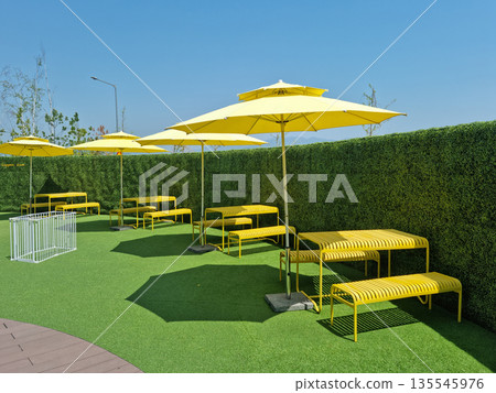 It is an outdoor cafe with parasols. It is an outdoor cafe with parasols. 135545976