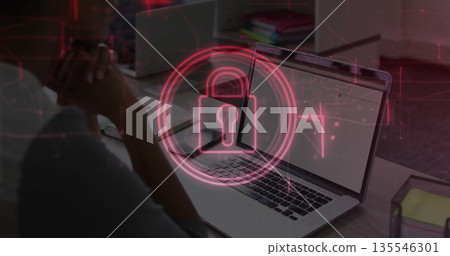 Displaying coworkers collaborating on laptops in office, red padlock icon overlaying laptop 135546301