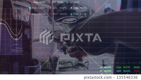 Barista in bib apron locking portafilter into machine at cafe counter, with tamper and stock charts Barista in bib apron locking portafilter into machine at cafe counter, with tamper and stock charts 135546336