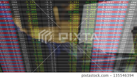 Business professional reviewing live financial market data in trading room, with digital display Business professional reviewing live financial market data in trading room, with digital display 135546394
