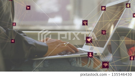 Typing Asian woman wearing ripped jeans, silver ring at moving train window, with laptop and icons Typing Asian woman wearing ripped jeans, silver ring at moving train window, with laptop and icons 135546430