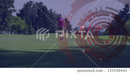 Walking female golfer wearing purple polo with glove toward golf ball on fairway, with HUD overlay Walking female golfer wearing purple polo with glove toward golf ball on fairway, with HUD overlay 135546443