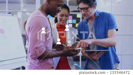 Examining digital screens, coworkers holding smartphone and tablet in office, with sticky notes 135546472