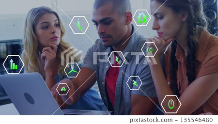 Collaborating three professionals analyzing data at office desk, with laptop and floating icons Collaborating three professionals analyzing data at office desk, with laptop and floating icons 135546480
