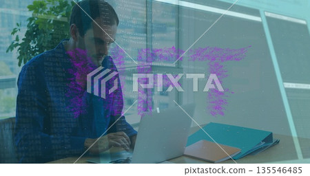 Typing man in checkered shirt using laptop at modern office desk, with colored folders, coffee mug 135546485