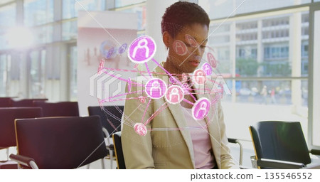Observing man in blazer studying holographic network over chairs in lobby, pink user-icon nodes 135546552