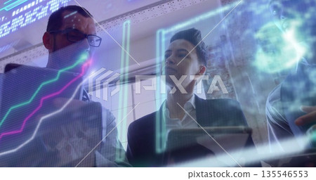 Reviewing team in suits examining charts in modern office with digital display and tablet computer Reviewing team in suits examining charts in modern office with digital display and tablet computer 135546553