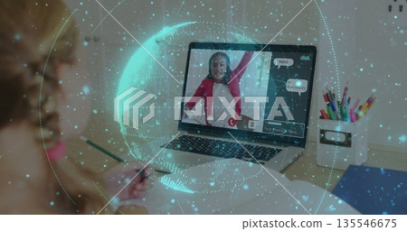 Writing girl using green pencil in notebook at home study desk, laptop, colored pencils, copy space 135546675