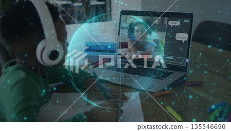 Drawing boy wearing headphones sketching at study area, chatting via laptop with holographic globe Drawing boy wearing headphones sketching at study area, chatting via laptop with holographic globe 135546690