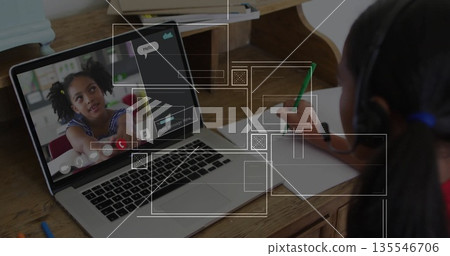 Showing laptop at home desk with peer speaking on headset, peer writing notebook using green pencil 135546706