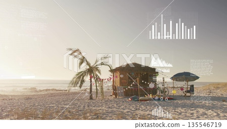 Standing thatched shack reflecting sunrise glow on sandy shore, with surfboards and bicycle 135546719