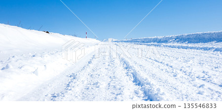 A simple scene of blue skies and packed snow on a winter road in Hokkaido A simple scene of blue skies and packed snow on a winter road in Hokkaido 135546833