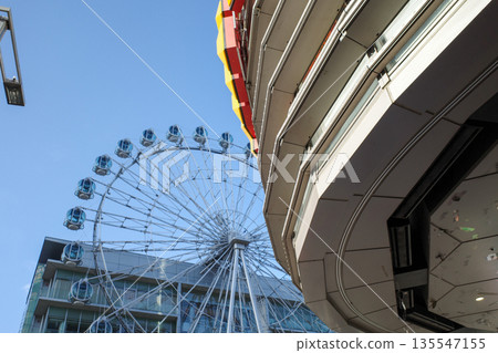 Ferris wheel against the blue sky 135547155