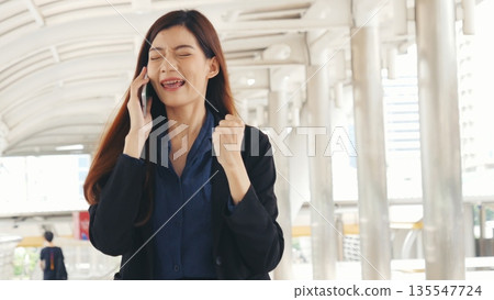Business woman using smartphone shopping online, call, texting message internet technology lifestyle. Asian woman using cellphone walking on city street. Smart phone smart confident woman modern city Business woman using smartphone shopping online, call, texting message internet technology lifestyle. Asian woman using cellphone walking on city street. Smart phone smart confident woman modern city 135547724