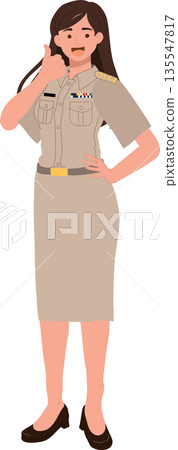 Asian female civil servant in Thai government uniform showing positive gesture in a professional environment. Asian female civil servant in Thai government uniform showing positive gesture in a professional environment. 135547817