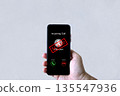 Smartphone screen shows unknown scam call, highlighting phone fraud risks, cyber threats 135547936