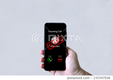 Smartphone screen shows unknown scam call, highlighting phone fraud risks, cyber threats Smartphone screen shows unknown scam call, highlighting phone fraud risks, cyber threats 135547936