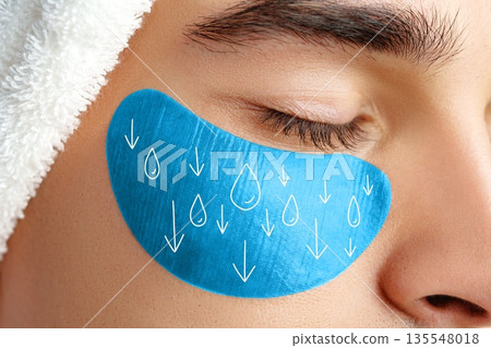 Person applying under-eye mask while relaxing at spa during day Person applying under-eye mask while relaxing at spa during day 135548018