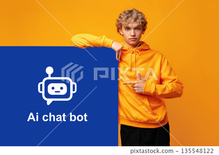 Young person points at sign showing ai chat bot on bright yellow background 135548122