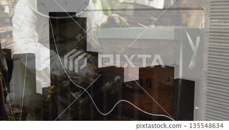 Man wearing top hat using tool polishing metal sphere in workshop, with graphical overlays 135548634