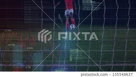 Soccer player in red jersey kicking ball behind goal net on grass turf, with data overlays Soccer player in red jersey kicking ball behind goal net on grass turf, with data overlays 135548637