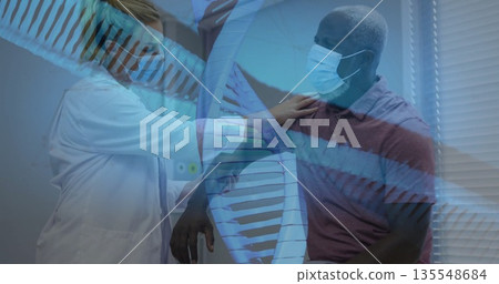 Female doctor placing stethoscope on patient shoulder in health clinic, showing DNA helix overlay 135548684