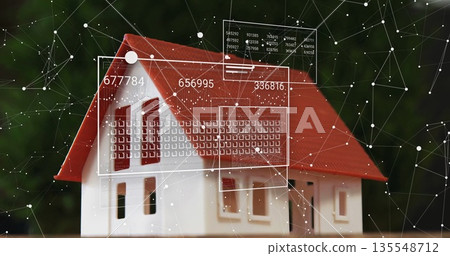 Showing miniature house model sitting on flat plane in garden, with digital panels displaying data 135548712