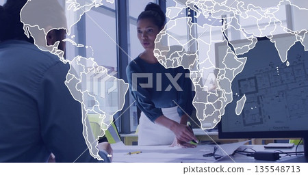 Presenting woman outlining floor plan on display screen in glass conference room with blueprints Presenting woman outlining floor plan on display screen in glass conference room with blueprints 135548713