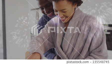 Cooking couple wearing bathrobe and long sleeve shirt stirring bowl in home kitchen, wooden spoon Cooking couple wearing bathrobe and long sleeve shirt stirring bowl in home kitchen, wooden spoon 135548745